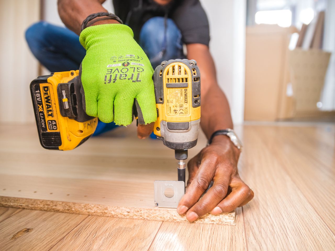 Handyman using a power drill while working on a job site